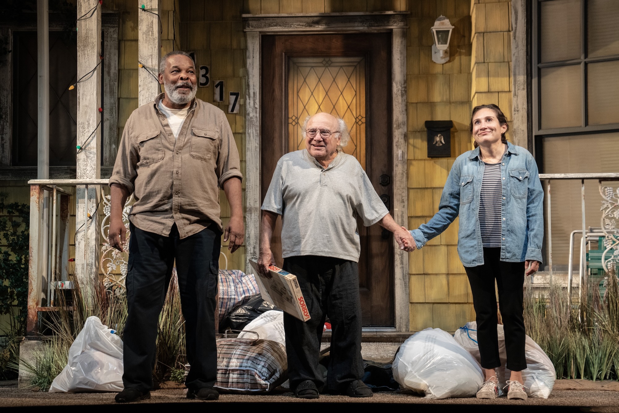 David Alan Grier, Danny Devito and female actress on stage for a curtain call for a production of I Need That. 